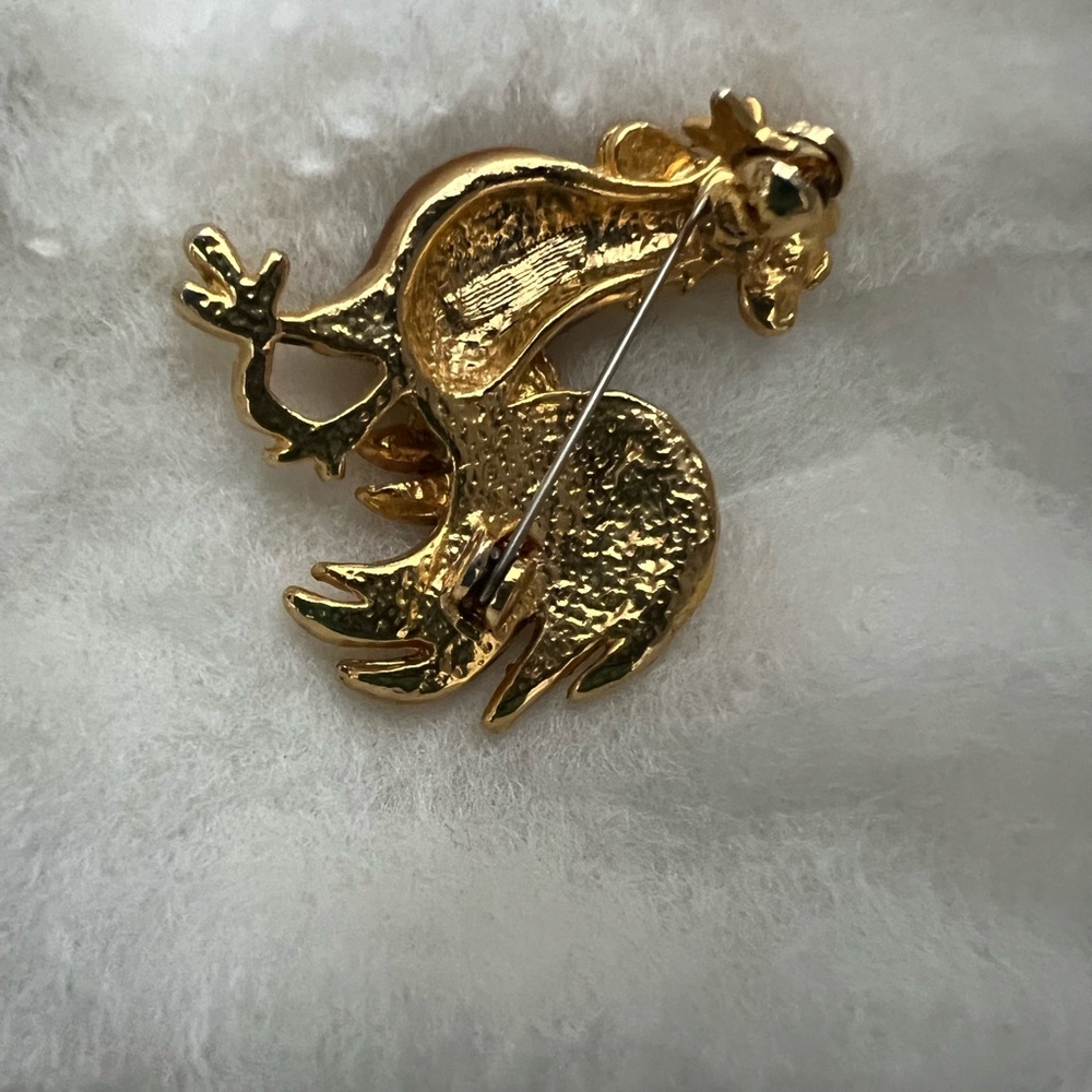 A very unique rooster lapel pin that would accent any and all social expo